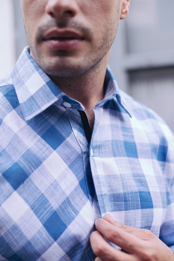 a close up of a person wearing a shirt and tie 